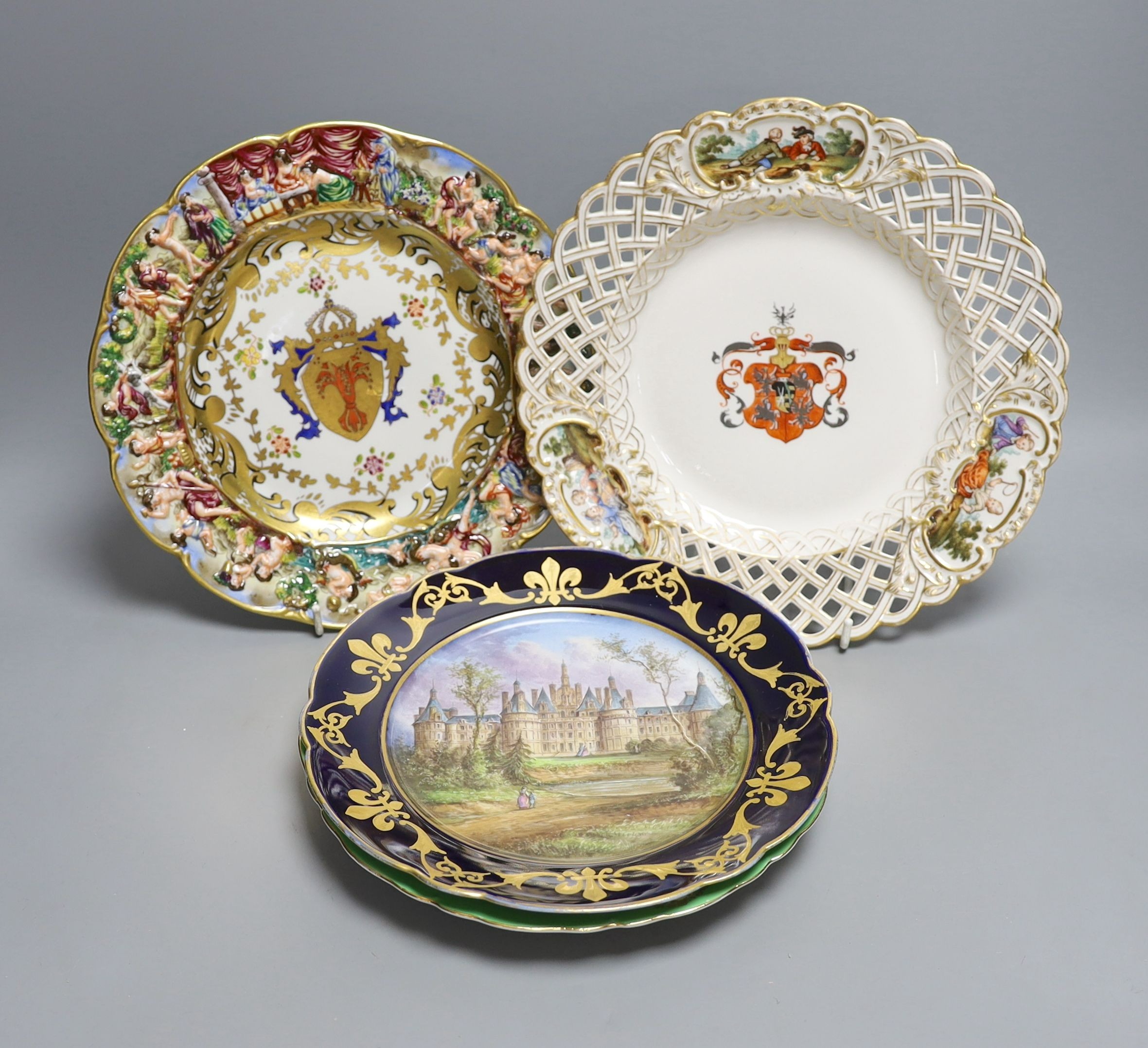 A Dresden armorial ribbon plate, two Sevres style plates and a Capodimonte style plate, late 19th/early 20th century (4)